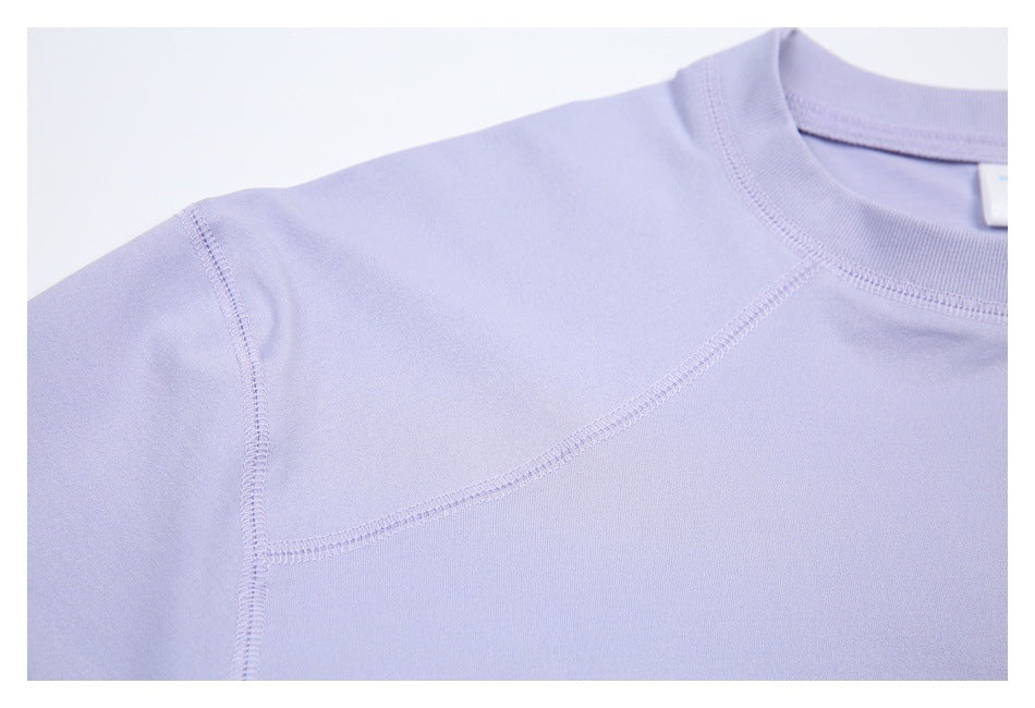 Close-up of the lavender shirt’s curved shoulder seam and short-sleeve construction.