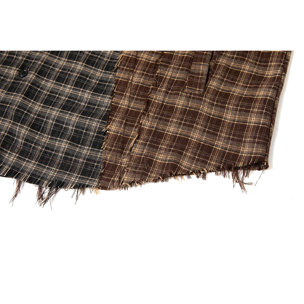 Close-up of raw shirt hems in charcoal and brown plaid colorways.