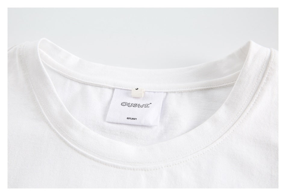 Close-up of the white shirt's crew neckline and sewn-in neck label.