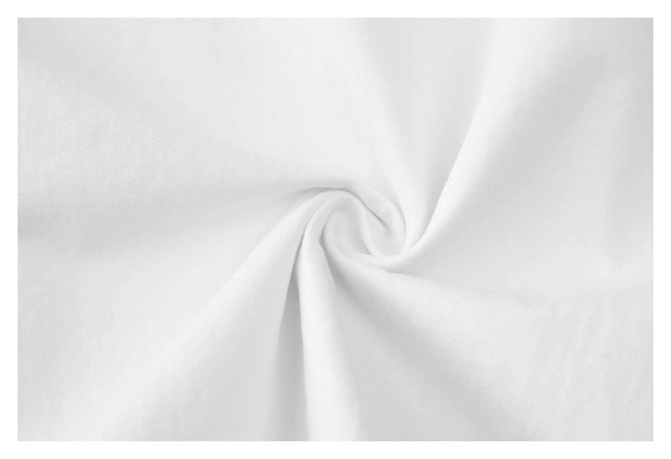 Close-up of white fabric gathered into a small swirl, showing its surface and folds.