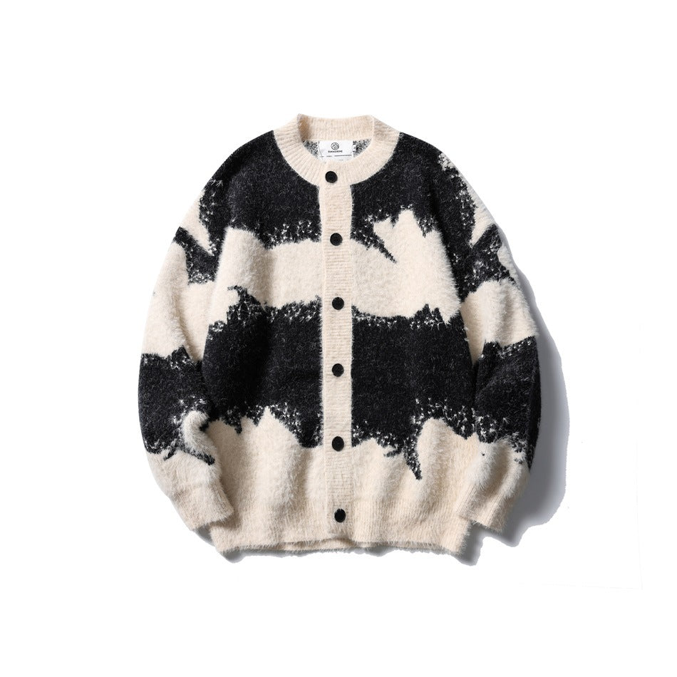Black and cream abstract-pattern fuzzy knit cardigan with black buttons and crew neck, flat lay front view