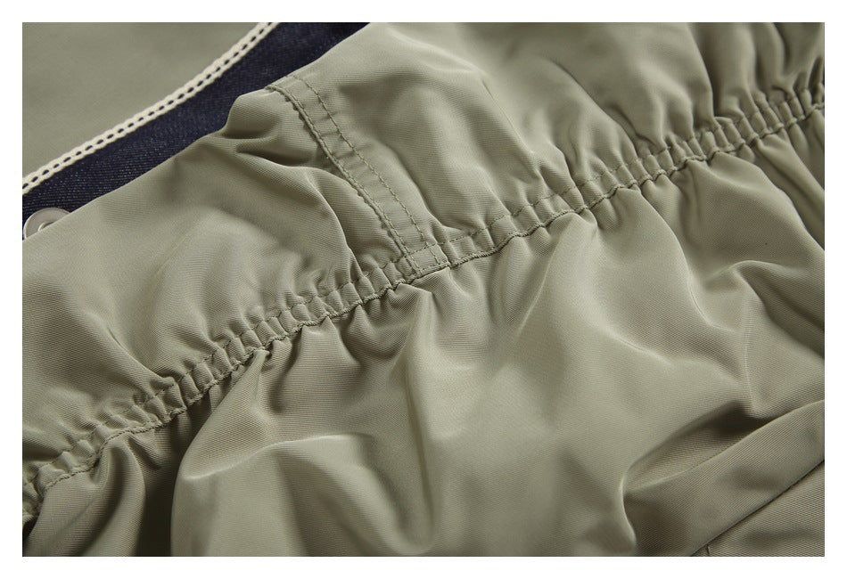 Close-up of an elasticized olive-gray waistband with stitched reinforcement.
