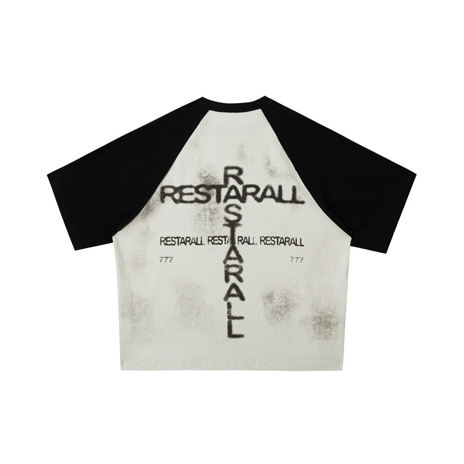 Back of an off-white raglan T-shirt with black sleeves and distressed black lettering and marks.