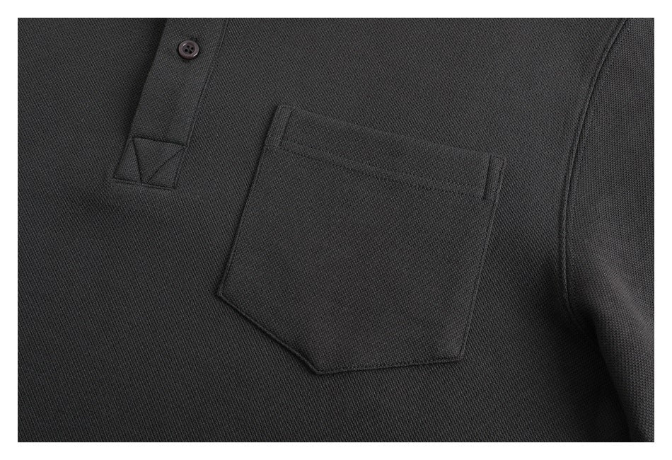 Close-up of a single patch pocket and button placket on the charcoal pullover.