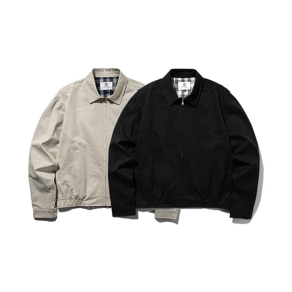 Front views of two jackets side by side, one light beige and one black, with collars and front zippers.