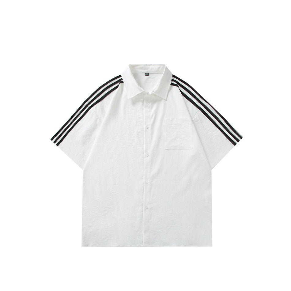 White short-sleeve button-up shirt with black triple stripes on the shoulders and sleeves, chest pocket, flat lay