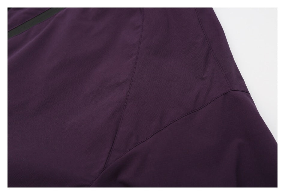 Close-up of purple garment panel seams and a curved stitched seam.