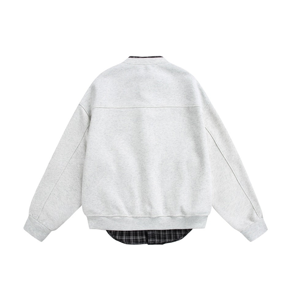 Back view of light heather gray jacket with yoke seam, ribbed hem and plaid layer showing below