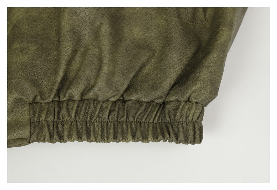 Close-up of the olive-green garment's gathered elastic waistband and textured fabric.