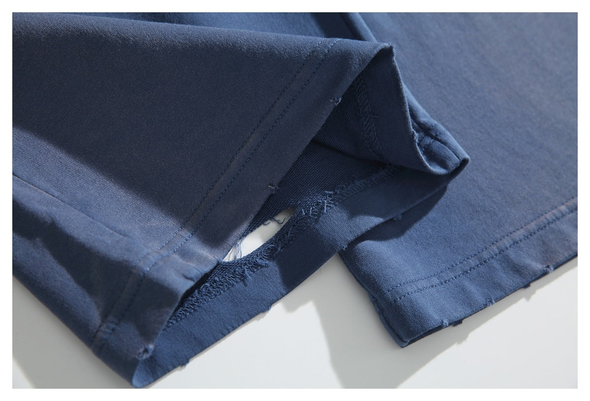 Close-up of a navy pant leg hem, showing the inside seam and stitching.