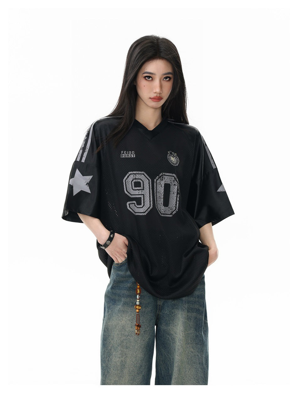 Model wearing a black mesh jersey with gray 90 and star graphics on the sleeves, shown from the front.