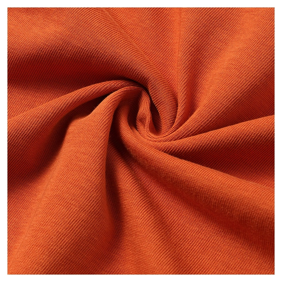 Close-up of orange knit fabric gathered into a spiral fold.
