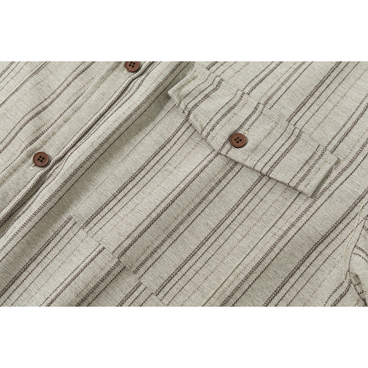 Close-up of a beige striped shirt front showing the button placket and flap chest pocket.