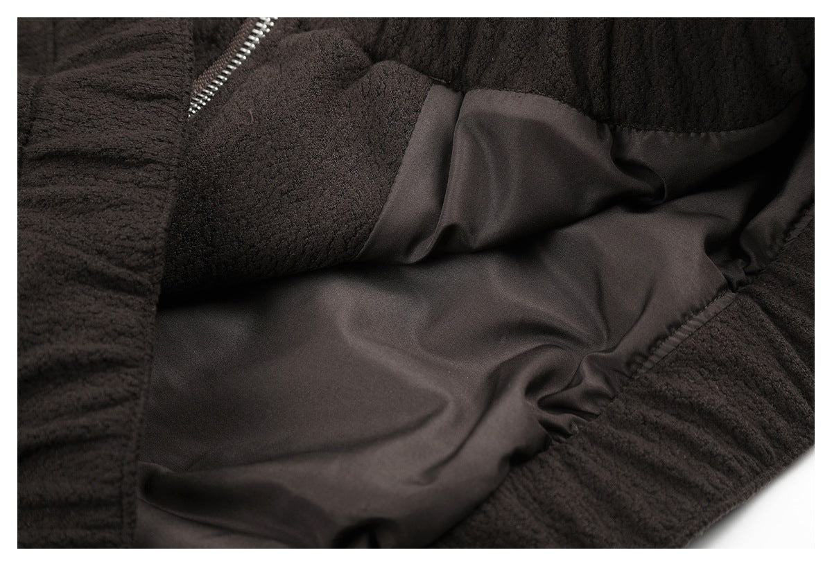 Close-up showing the dark smooth inner lining and textured outer fabric of a garment.