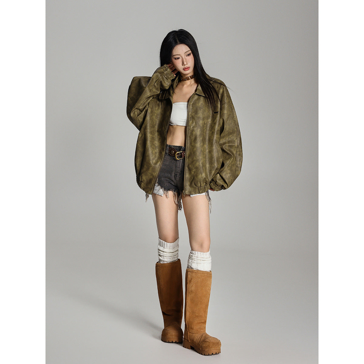 Model wearing an oversized olive mottled zip jacket with a wide collar, elastic cuffs and hem.
