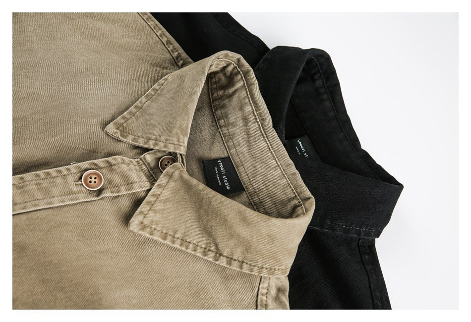Close-up of tan and black button-up shirts showing their collars, buttons, stitching, and sewn neck labels.
