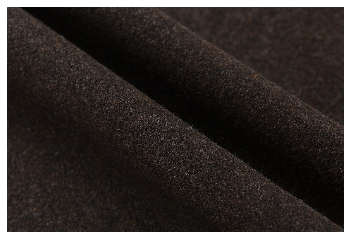 Close-up of dark brown textured fabric arranged in soft folds.