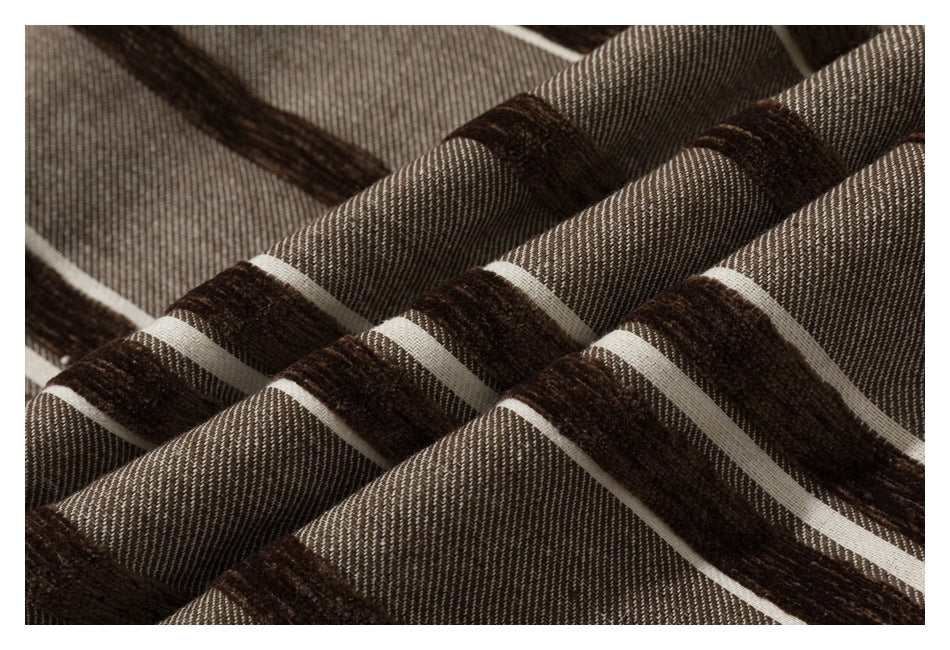 Close-up of draped taupe fabric with broad dark brown and narrow cream stripes.