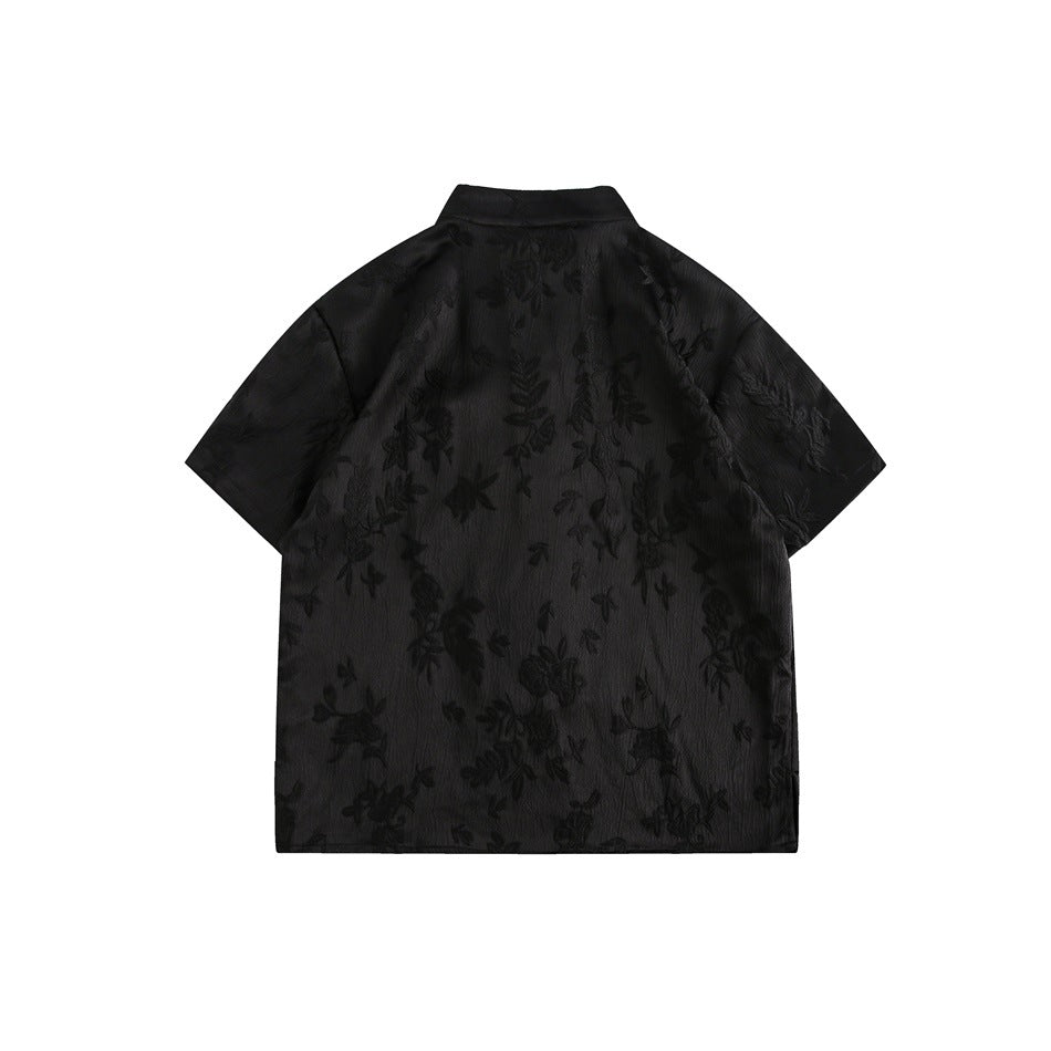 Back view of a black short-sleeve mandarin-collar shirt with an all-over floral pattern.