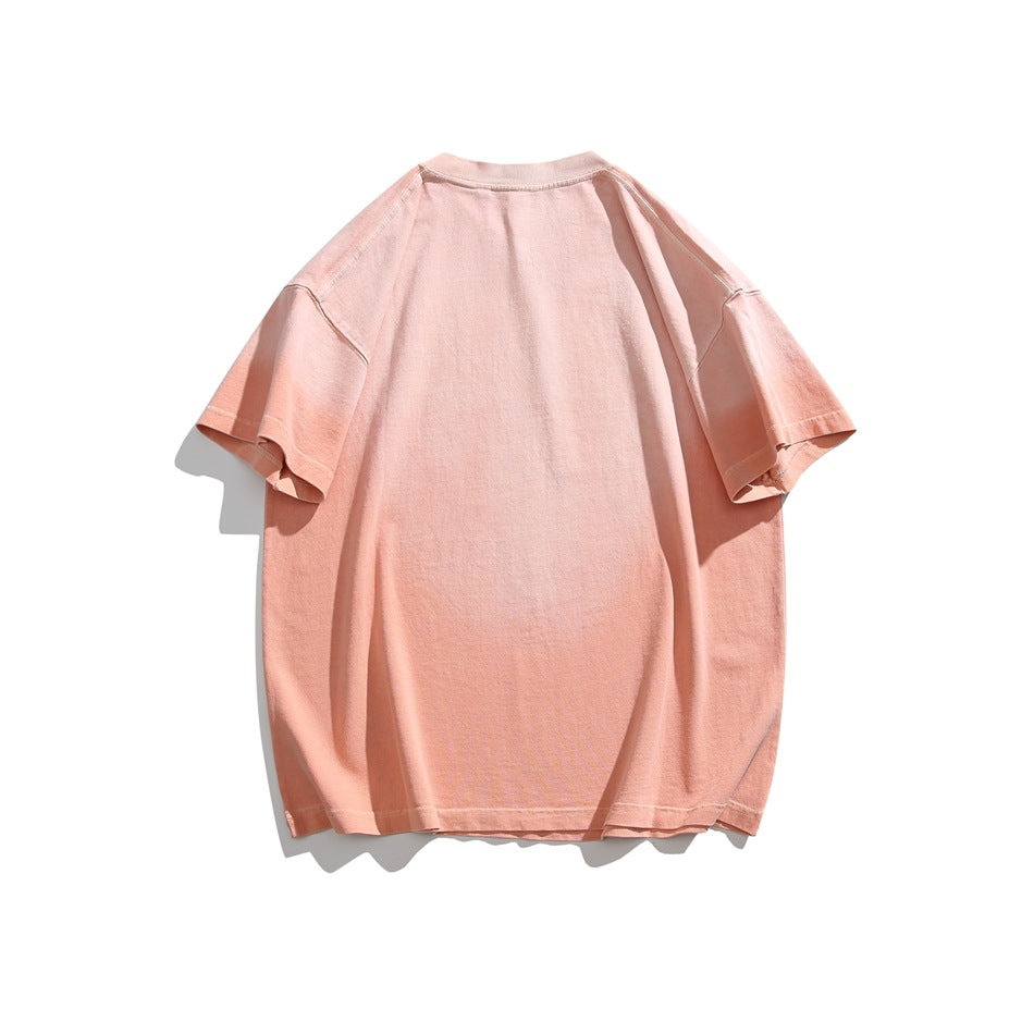 Back view of a plain oversized peach short-sleeve T-shirt laid flat on white.