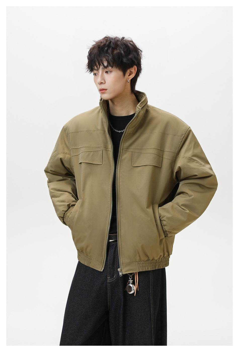 Three-quarter view of a model wearing an olive-brown zip jacket with flap chest pockets and elastic trim.