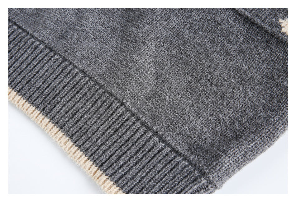Close-up of a gray ribbed knit edge with narrow cream trim.
