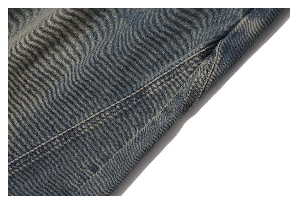 Close-up of a long stitched seam on faded dark blue denim.