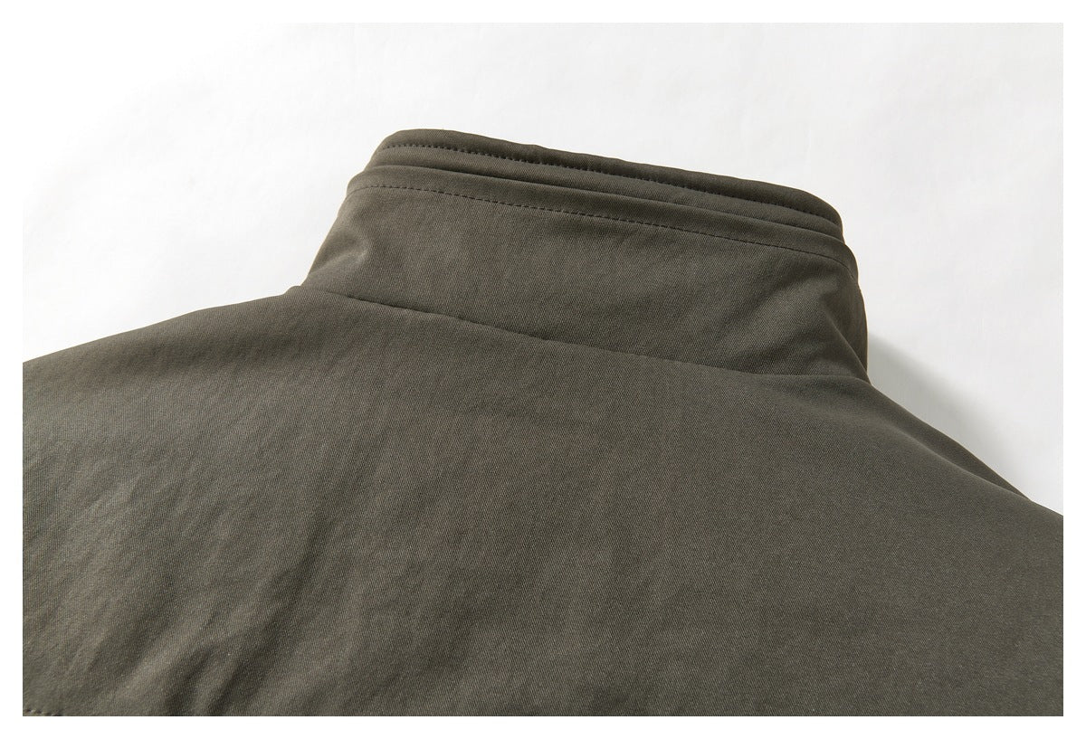 Close-up of the dark olive jacket's back collar and upper back.
