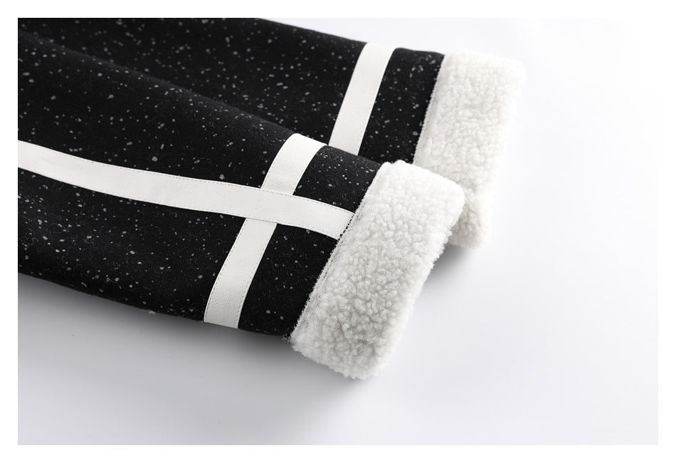 Close-up of a jacket sleeve cuff with white fleece edging and white bands on black speckled fabric.