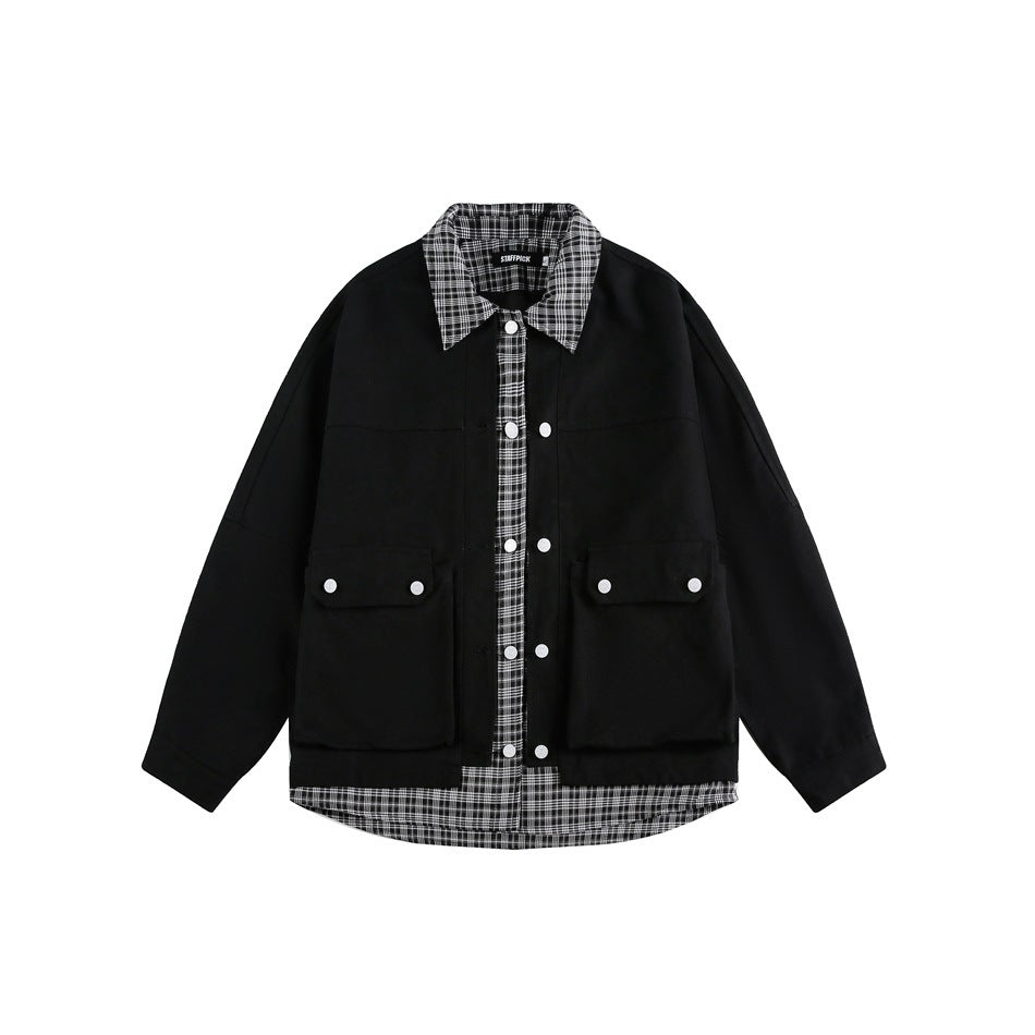 Front view of a black oversized jacket with white buttons, flap pockets, and a black-and-white plaid collar, placket, and