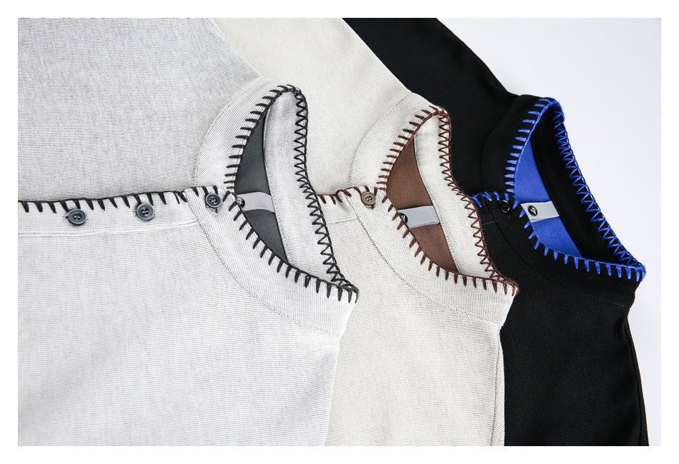 Close-up of gray, ivory, and black sweatshirts showing contrast stitching around the necklines and button plackets.