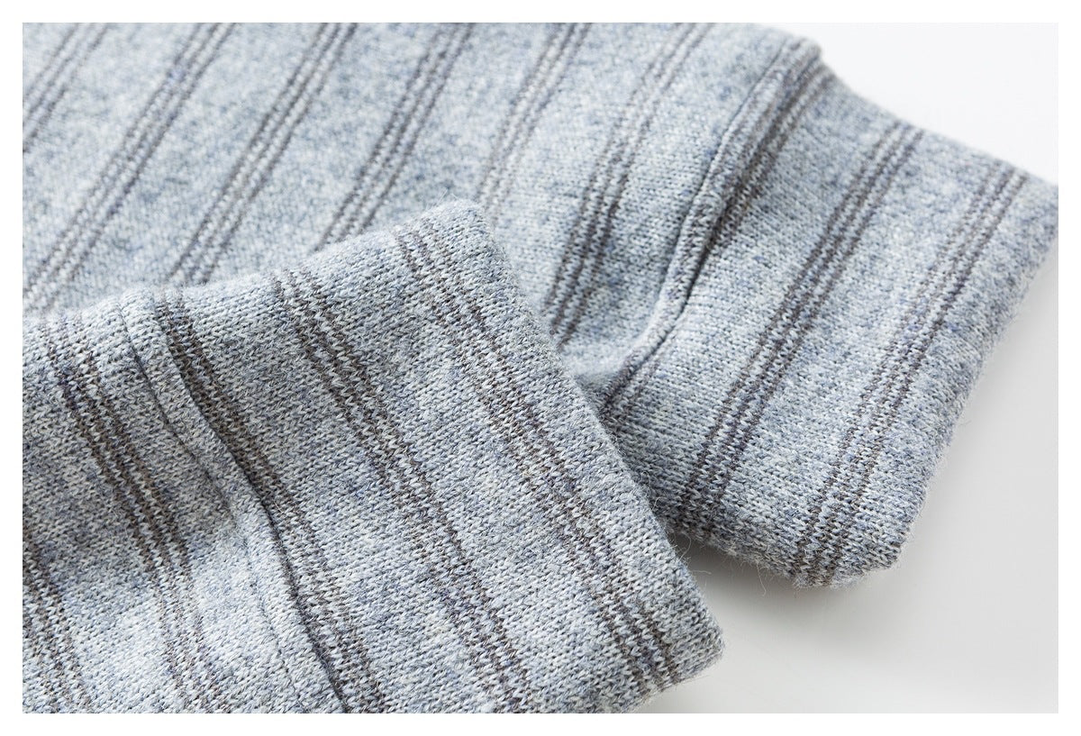 Close-up of a folded ribbed cuff on gray knit fabric with narrow dark stripes.