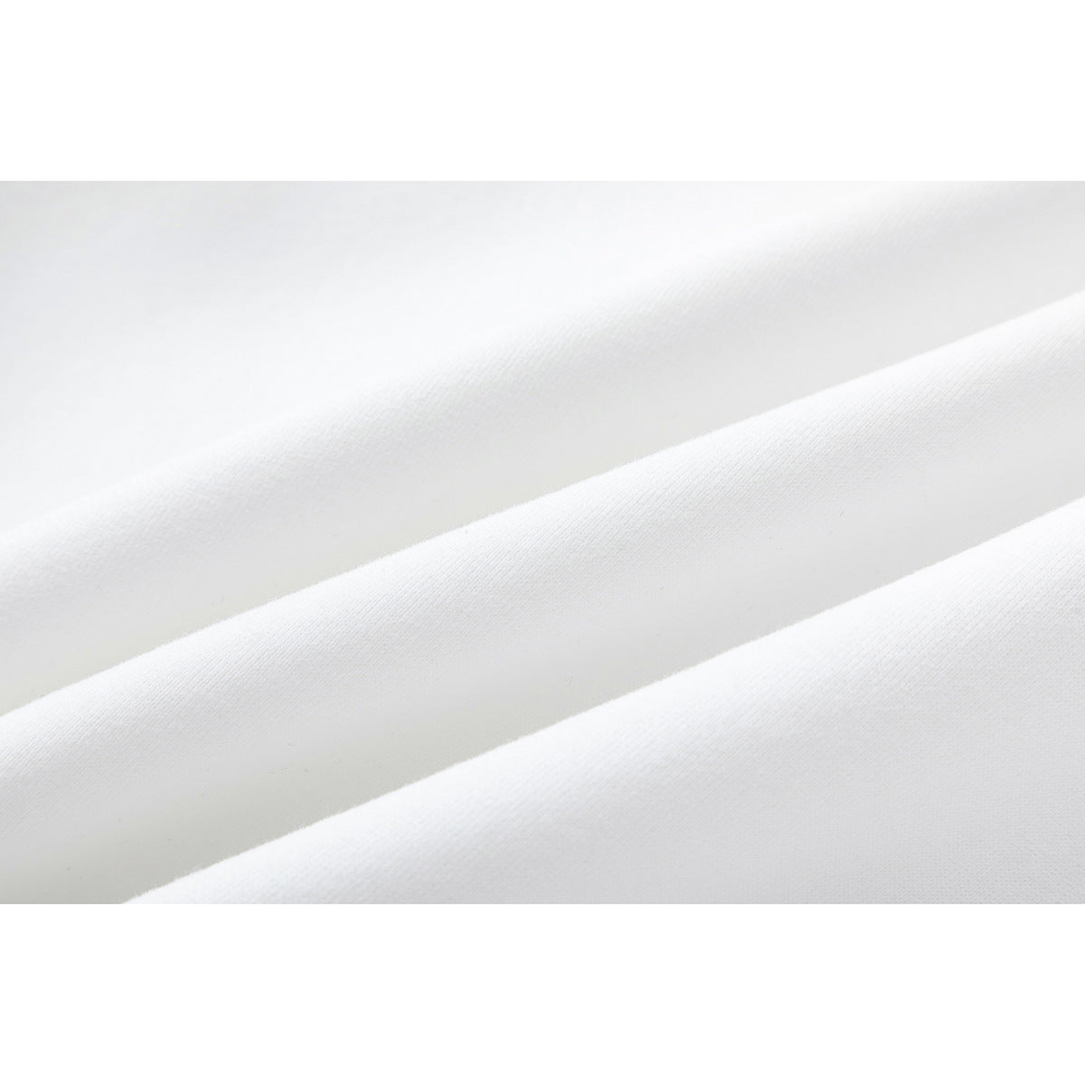 Close-up of plain white fabric draped in soft folds.