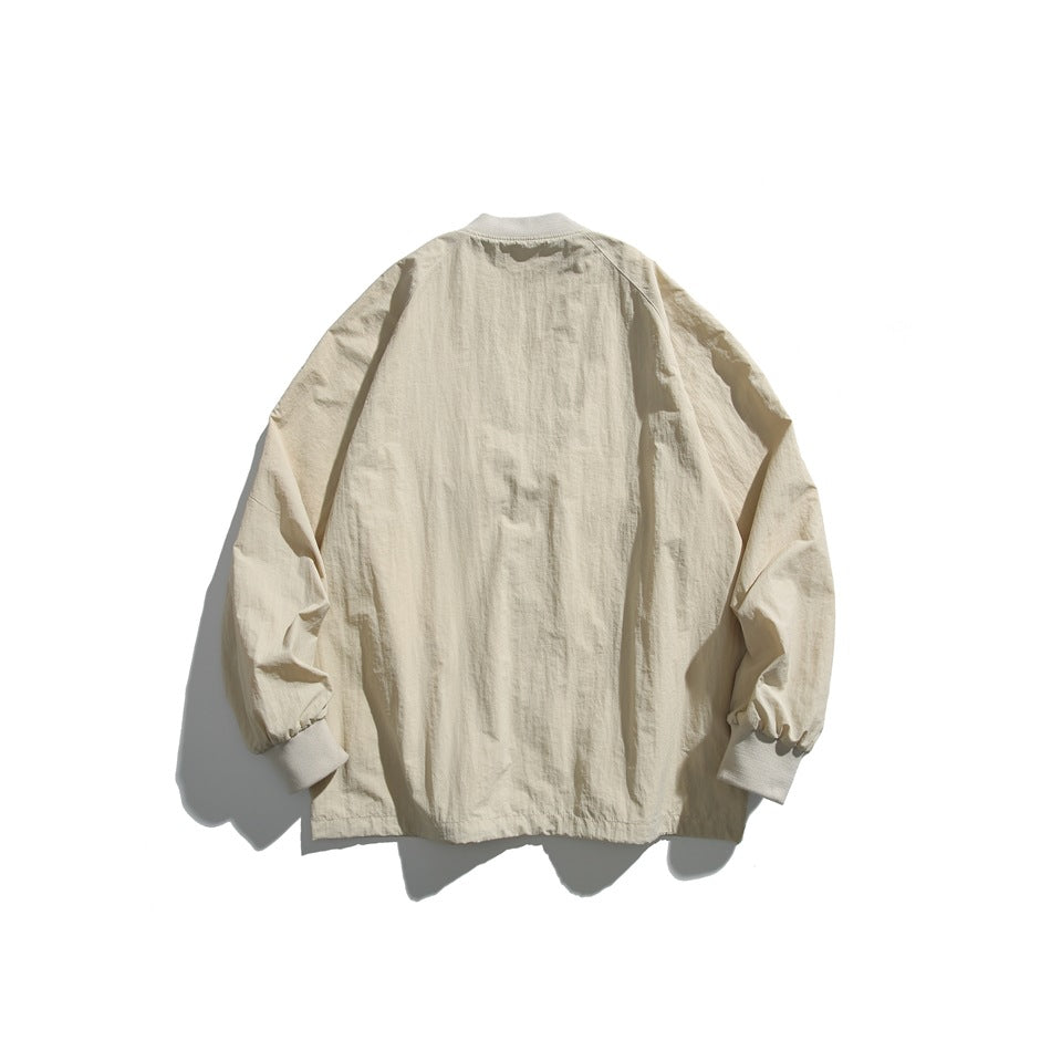 Back view of a light beige jacket with a short collar, long sleeves, and ribbed cuffs on a white background.