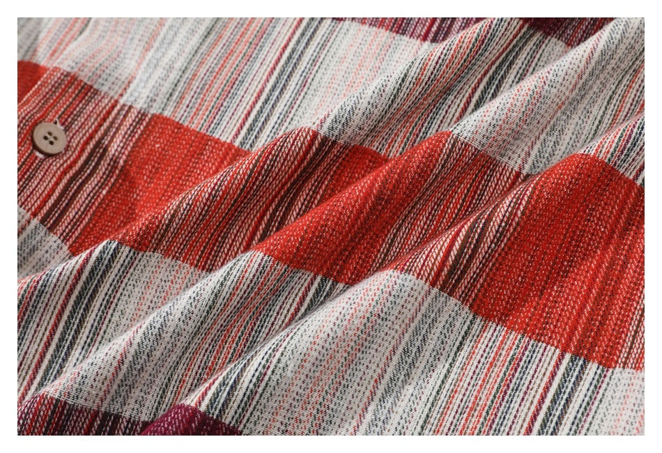 Close-up of red, white, and dark striped woven fabric with a small tan button.