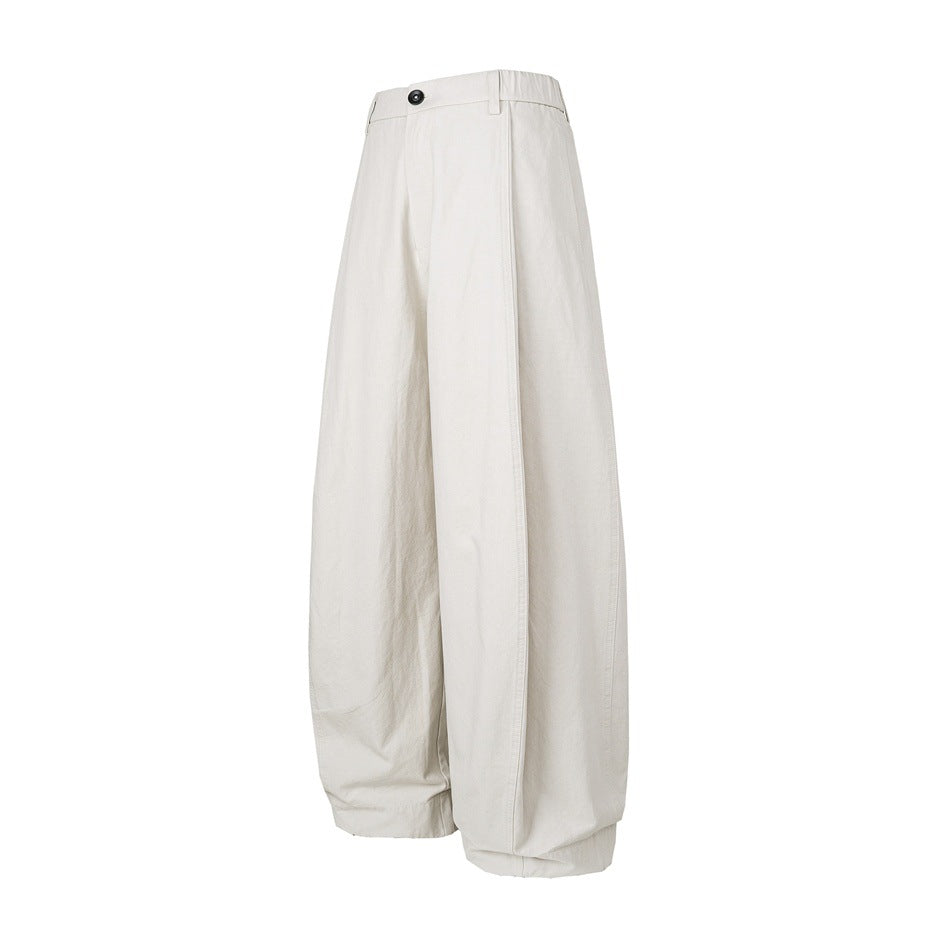 Front view of ivory wide-leg trousers with a button closure and softly gathered hems, shown on a white background.