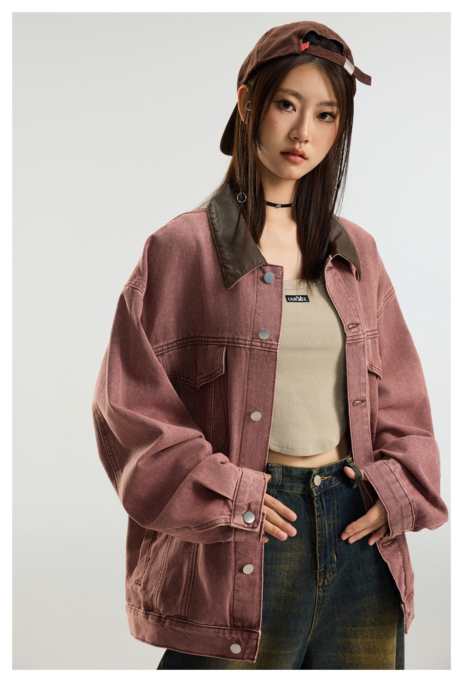 Model wearing a dusty rose oversized jacket with a dark brown collar, layered over a beige crop top.