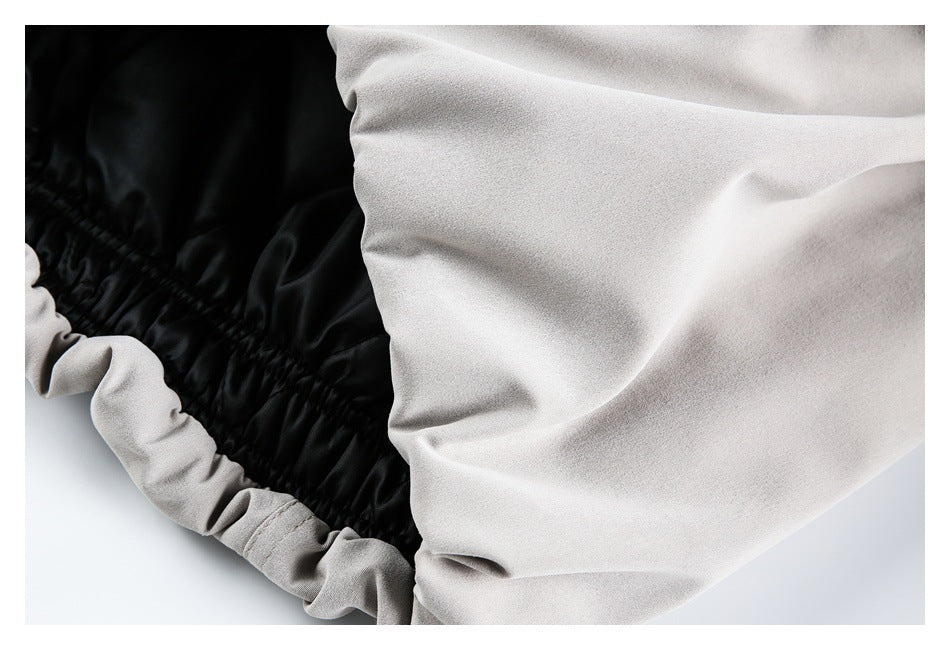 Close-up showing the light gray jacket's gathered edge and black inner lining.
