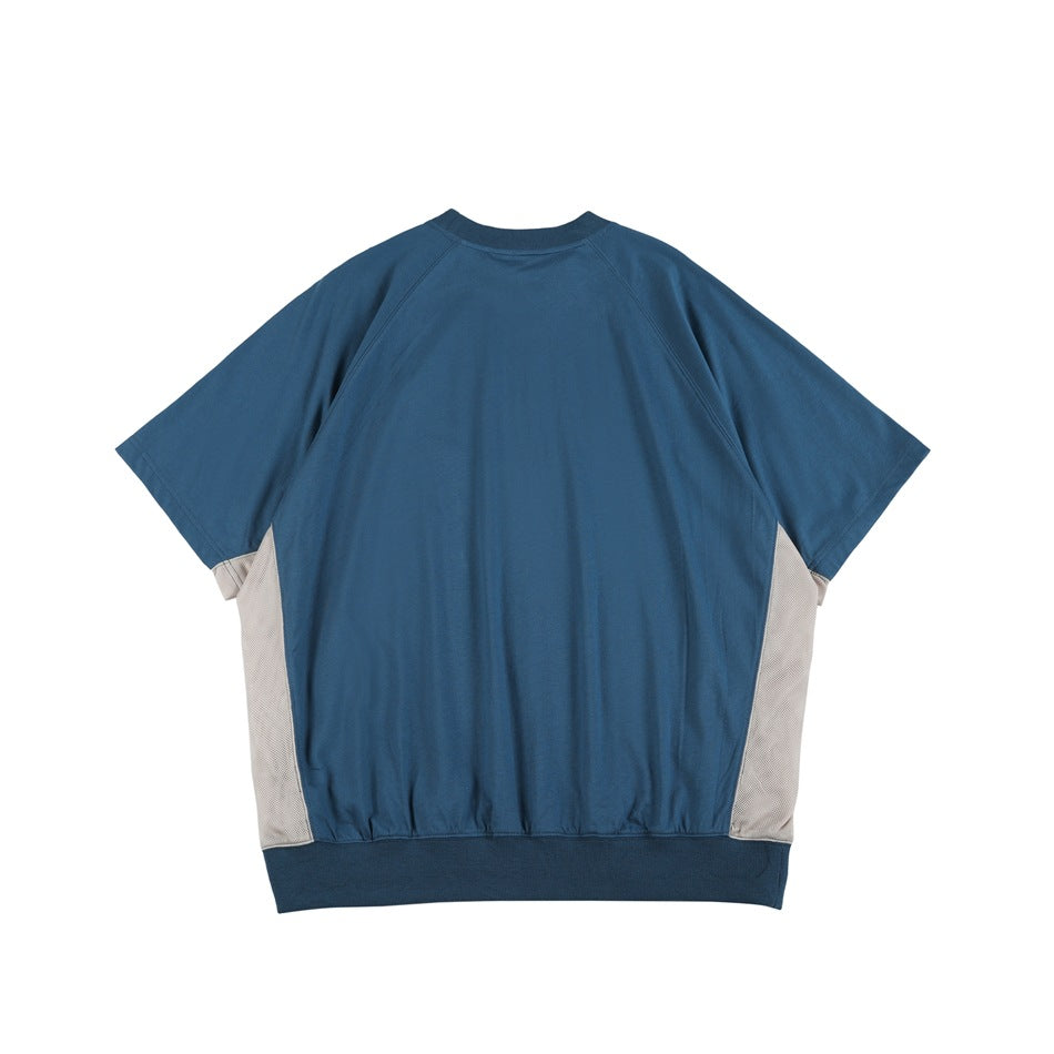 Back view of blue short-sleeve raglan tee with ribbed collar and hem and light gray side panels