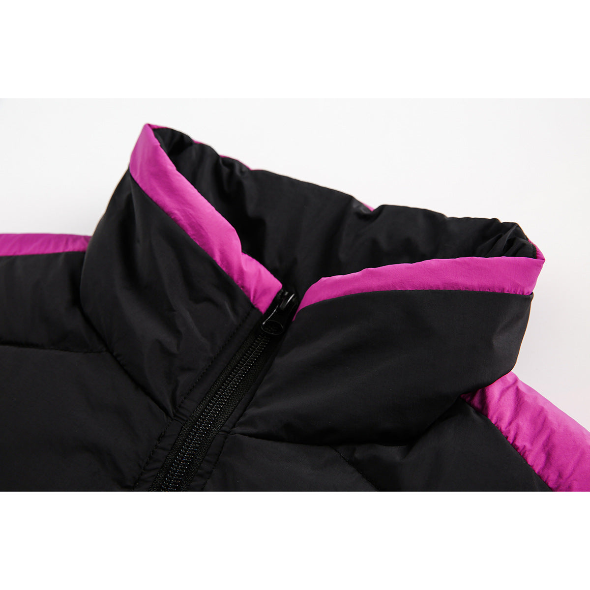 Close-up of a black padded jacket collar with bright magenta lining and a black front zipper.