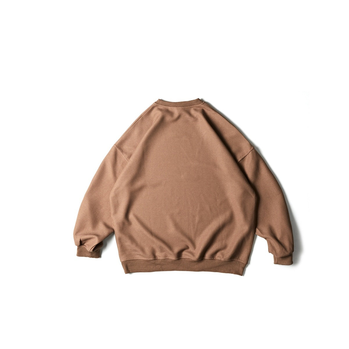 Back view of a taupe brown textured crewneck sweatshirt with dropped shoulders and ribbed cuffs and hem.