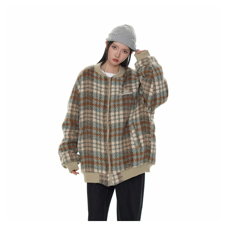 Model wearing a blue-gray, cream, and rust plaid zip-front jacket with beige ribbed trim and a gray knit beanie.