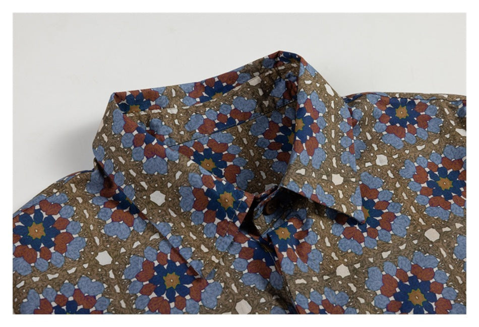Close-up of a button-up shirt collar in a brown, rust, and muted blue floral geometric print.
