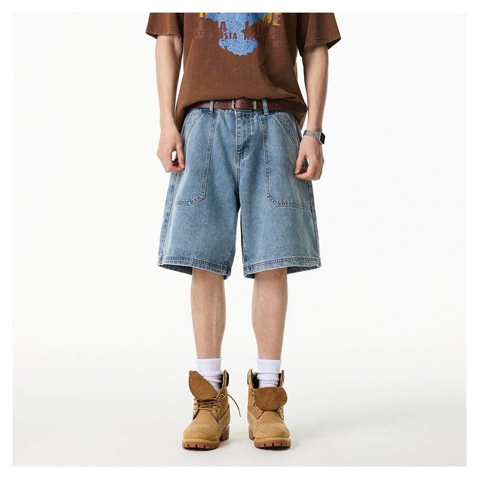 Model wearing light blue denim knee-length shorts with front panel pockets, brown tee, belt and tan boots, front view