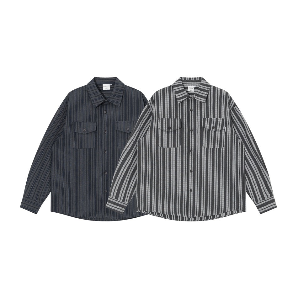 Two long-sleeve button-up shirts with vertical stripes and chest pockets, one dark charcoal and one gray.