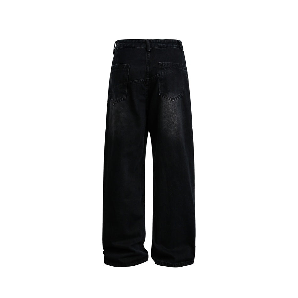Back view of black, extra-wide-leg jeans with two rear patch pockets on a white background.