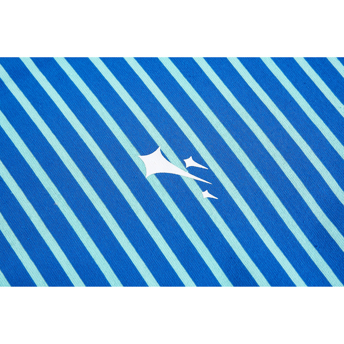 Close-up of blue and pale aqua diagonal stripes with a small white abstract graphic on the shirt.