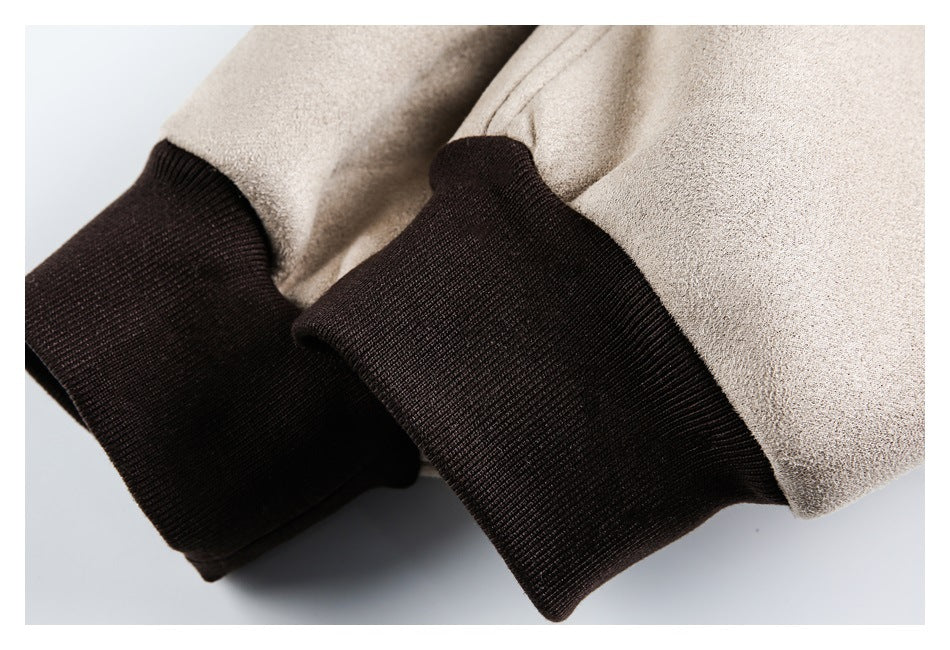 Close-up of beige jacket sleeves ending in dark brown rib-knit cuffs.