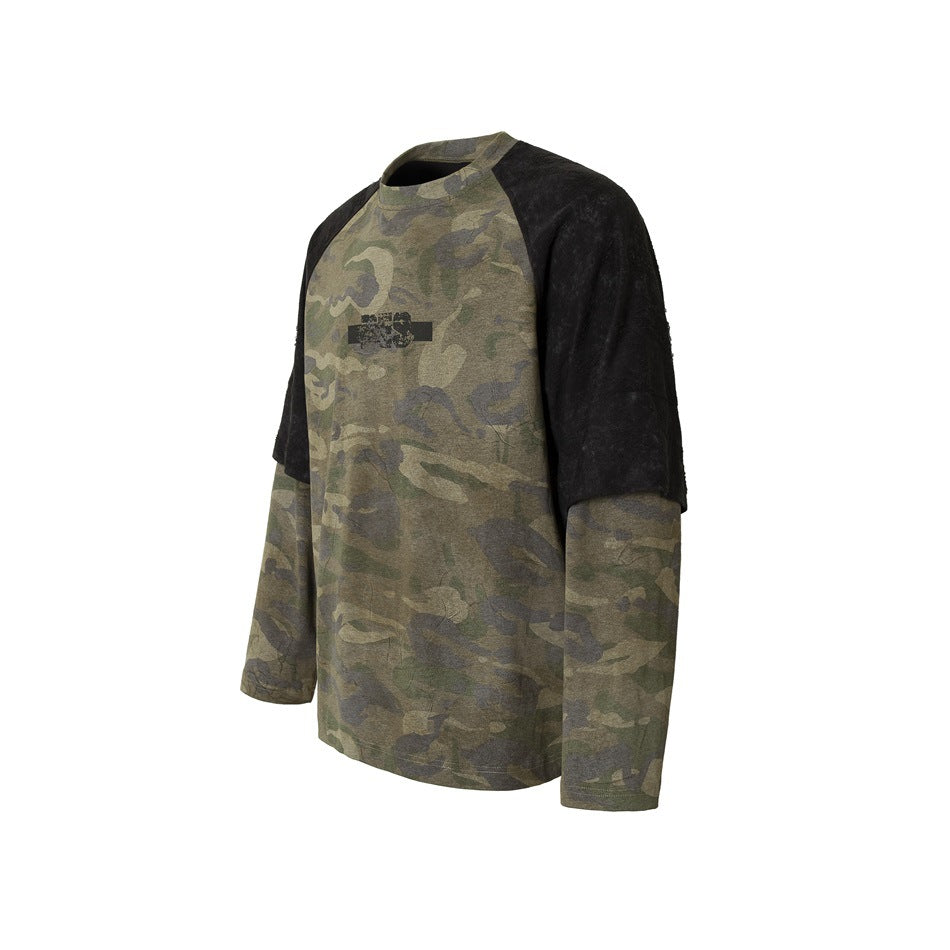 Front three-quarter view of an olive camouflage long-sleeve top with black short sleeve panels and distressed chest print.