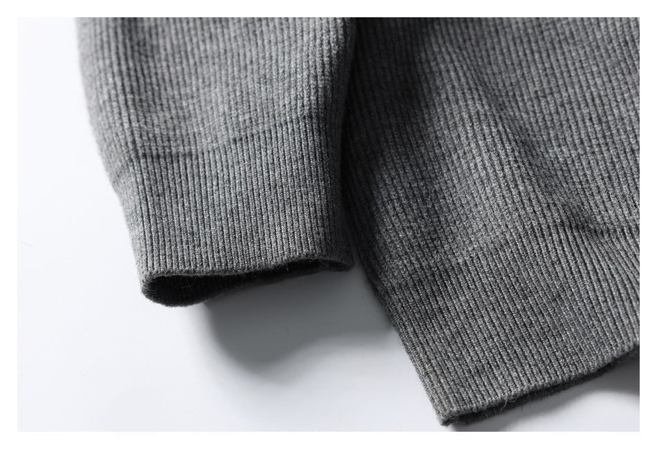 Gray rib-knit sleeve cuff beside the garment's ribbed hem.